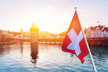 Panoramic view of city center of Lucerne with famous Chapel Bridge and lake Lucerne with Swiss flag, Switzerlandの写真素材