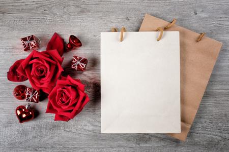 Happy Valentine's Day Concept with red roses, gift boxes, paper bag and space for textの写真素材