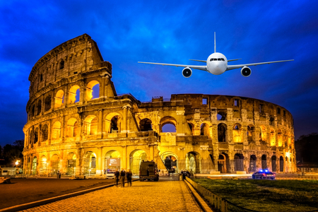 Front of real plane aircraft, on Colosseum Nigth view of Rome, Italy backgroundの写真素材