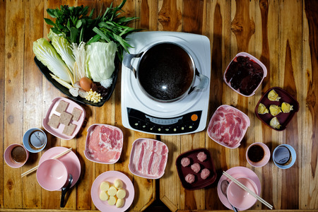 Thai style hot pot with delicious food ingredient on wood backgroundの写真素材