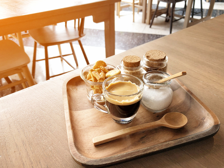 Espresso coffee and cracker on wooden table backgroundの写真素材