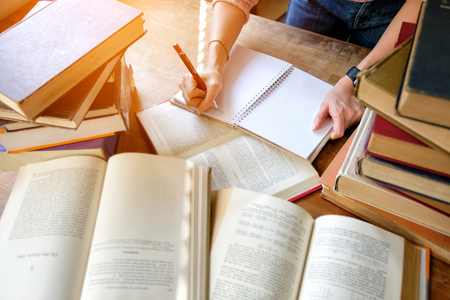 Young woman studying in libraryの写真素材