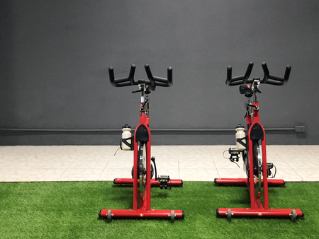 Red fitness cycle wheel in the gym loft styleの写真素材