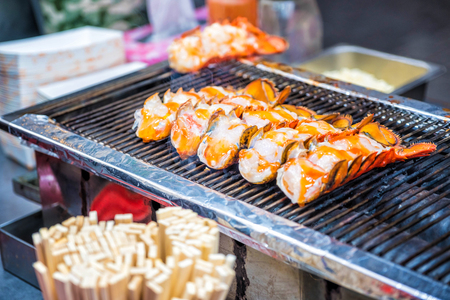 Roasted lobster with cheese at Myeong-dong street food in Seoul, South Koreaの写真素材