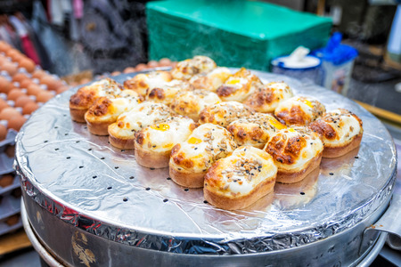 Egg bread with almond, peanut and sunflower seed at Myeong-dong street food, Seoul, South Korea の写真素材