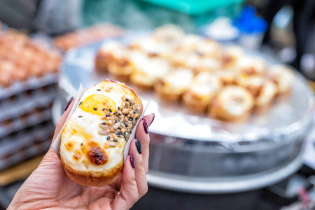 Egg bread with almond, peanut and sunflower seed at Myeong-dong street food, Seoul, South Korea の写真素材