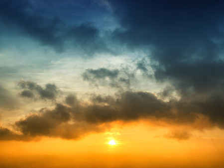 Skyscape of sunset view colors of orange and white clouds against blue skyの写真素材