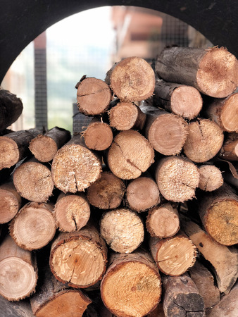 A pile of stacked firewood, prepared for cooking pizza in the Restaurantの写真素材