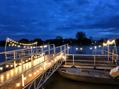 Wooden pier in Twilight beautiful sea with ship, view river and fishing boat of Mahachai Samut Sakhon Thailandの写真素材