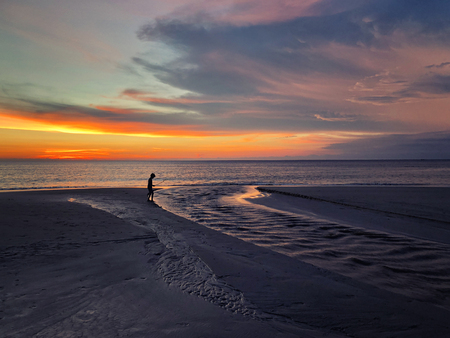 Panoramic view of sunset kid playing on the beach at Karon beach in Phuket, Thailandの写真素材