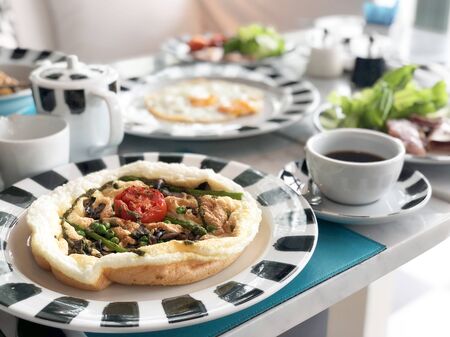 Herb omelette with chives and oregano sprinkled healthy breakfastの写真素材