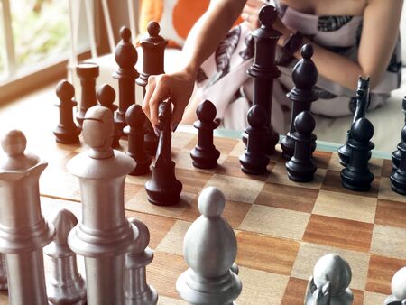 Close up of hands of young  woman playing chess.の写真素材