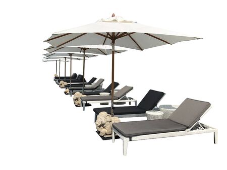 Relaxing pool bed beside swimming pool on white backgroundの写真素材