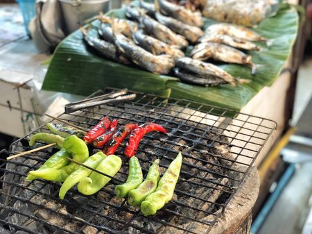 Bell pepper grill on stove in street marketの写真素材