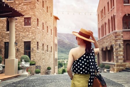 Woman wearing a planter panama hat visiting an Italian style village in summerの写真素材