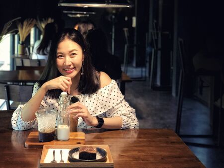 Woman drinking coffee in a cafeの写真素材