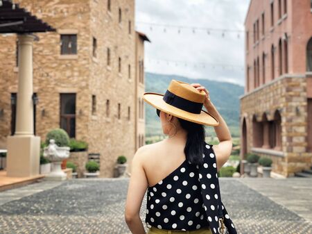 Woman wearing a planter panama hat visiting an Italian style village in summerの写真素材