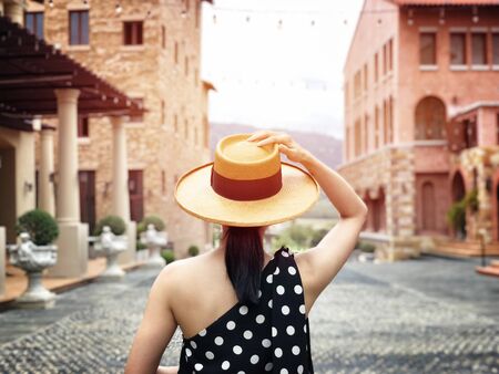Woman wearing a planter panama hat visiting an Italian style village in summerの写真素材