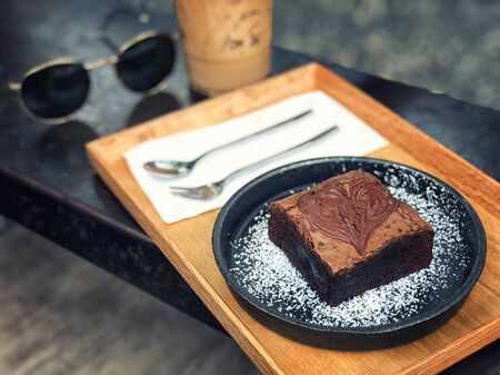 Dark chocolate brownies served with coffee の写真素材