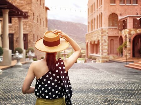 Woman wearing a planter panama hat visiting an Italian style village in summerの写真素材