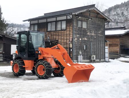 Orange Snowplow Truck Remove the Snow in Shirakawago, Japanの写真素材