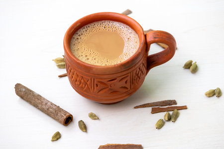 A cup of hot masala tea or masala chai in a traditional natural clay cup. Kullad chai or clay pot tea, is a traditional way of serving masala chai.の写真素材
