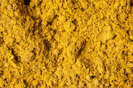 Vibrant close-up of coriander powder texture. Freshly ground spice showcasing its natural detail, ideal for food photography, culinary ingredient displays, and cooking backgrounds.の写真素材