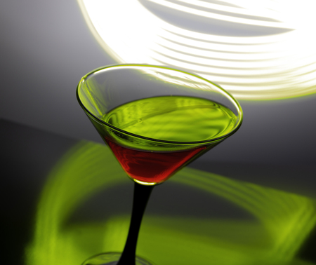 red Wine in a glass on a beautiful colored backgroundの写真素材
