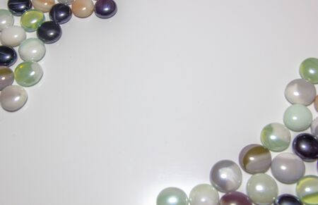 background of colored round smooth colored stones with a place under the inscriptionの写真素材
