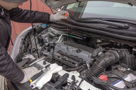 the car mechanic is engaged in repair of cars repair oil change change of wheels polishing of a body
