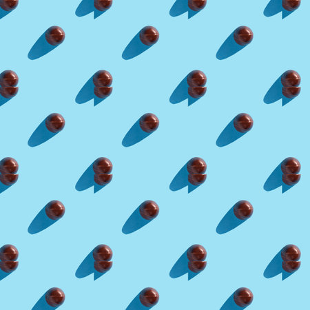 round chocolate candy on a blue background patternの写真素材