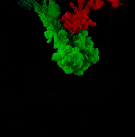 the jet of red paint meets the green paintの写真素材