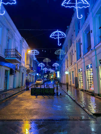 the street of the night city with a beautiful blue illumination in the form of umbrellasの写真素材