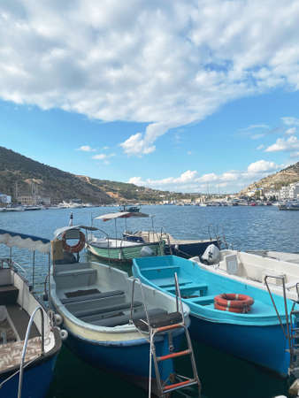 small boats are moored to the pier in the sea bayの写真素材