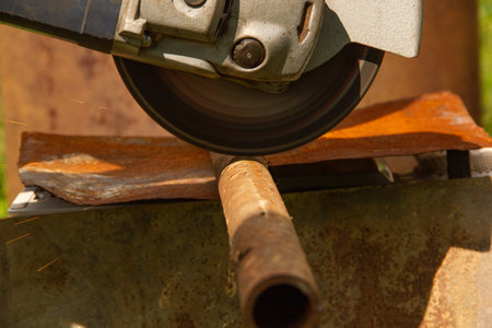 A grinding machine is used to cut a thin metal pipeの写真素材