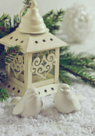 beautiful christmas decorations and fir branch on white snow background in vintage styleの写真素材