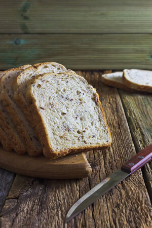 sliced into portions bread with grains on a cutting board