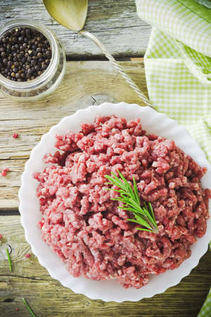  minced meat and spices in a bowl on the tableの写真素材