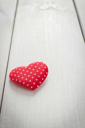 bright red valentine on white wooden backgroundの写真素材