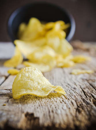crispy potato chips scattered on the tableの写真素材