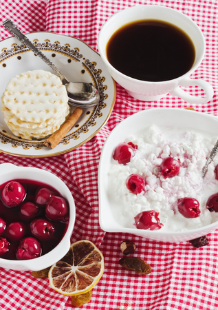 breakfast with cottage cheese and cherries on the tableの写真素材