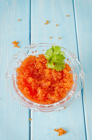appetizing salmon red caviar in glass bowlの写真素材