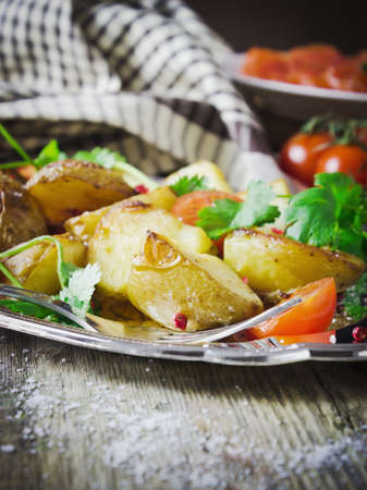 dinner of baked potatoes and fresh vegetablesの写真素材