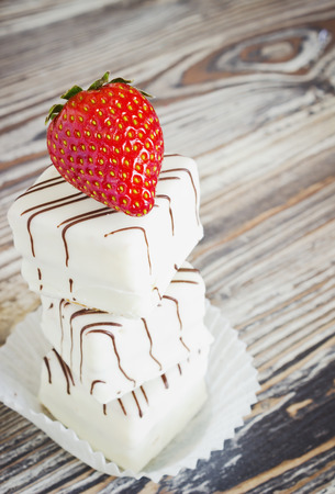cakes covered with white chocolate and fresh strawberriesの写真素材