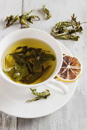 fresh tea from the leaves of mint on a tableの写真素材