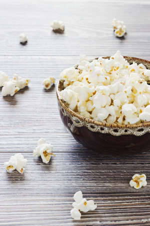 popcorn in bowl on wooden background. selective focusの写真素材