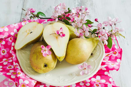 fresh ripe pears in a bowl on bright napkin.の写真素材