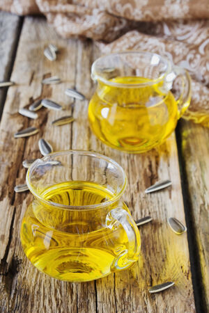 vegetable oil in a small jug on old wooden background.health and diet foodの写真素材