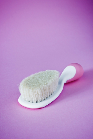 baby brush for newborn children on purple background. copy space for textの写真素材