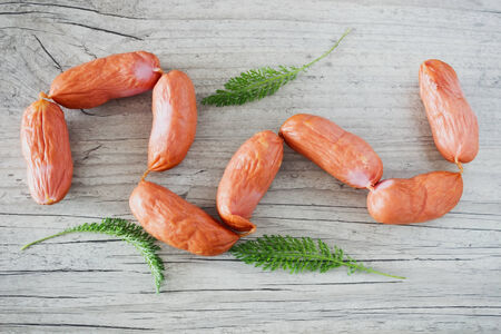 raw sausages for grilling on a wooden background. top view. meat products.